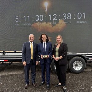 Minister Fedeli, Canada Rocket Company CEO Hugh Kolias, and Invest Ontario VP Heather Potter stand beside a clock moving six years closer to the facility's opening.