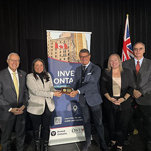 Minister Fedeli, Hitachi Energy executives, and Heather Potter and John Millen from Invest Ontario pose at the announcement event.